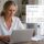 Woman using a laptop at a table with email server settings and device icons overlaid on the image.